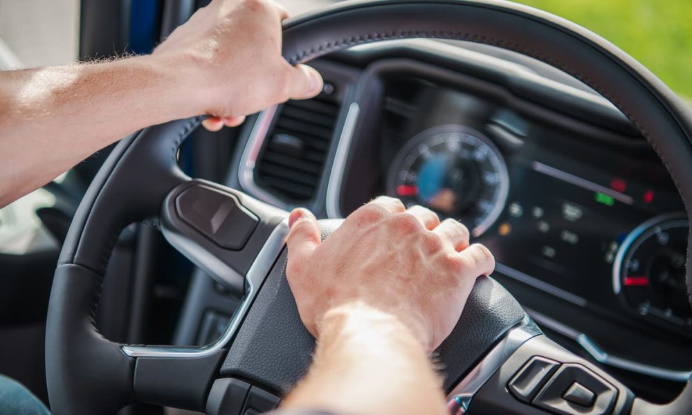 truck-driver-gripping-steering-wheel-while-navigat-2025-03-16-20-03-42-utc-1